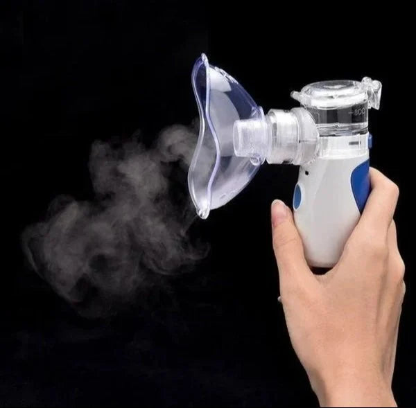 Hand holding a handheld with steam on a black background