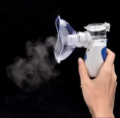 Hand holding a handheld with steam on a black background